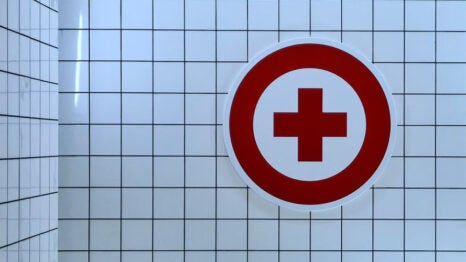 Image of a red cross on a white tile wall