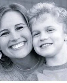 Portrait photo of Laura and a child.