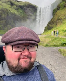 Photo of Guðjón in front of a waterfall.