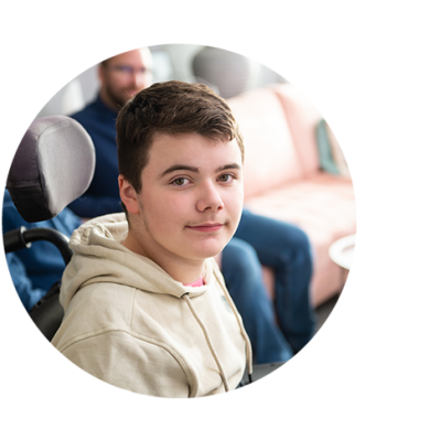 Boy in light colored hooded sweatshirt looking to his right